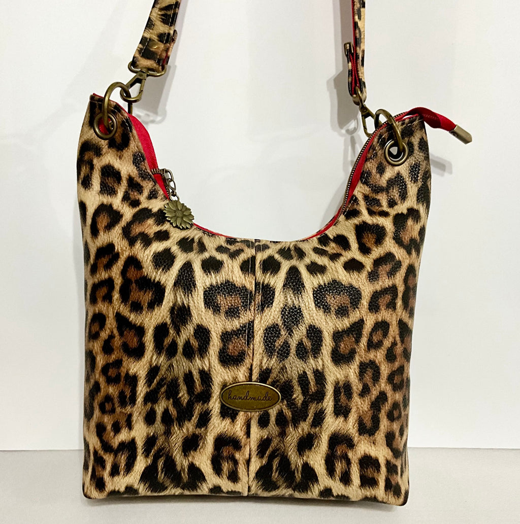 Leopard print Uptown Swing bag with strap extended