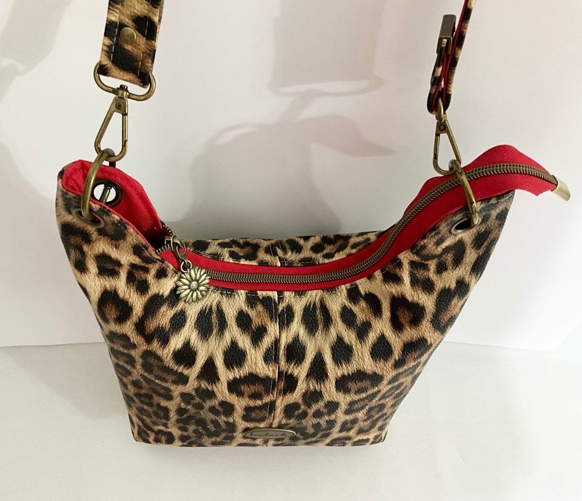Curved top zipper on leopard print Uptown Swing bag