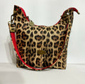 Uptown Swing leopard print shoulder bag with red accented strap, front view